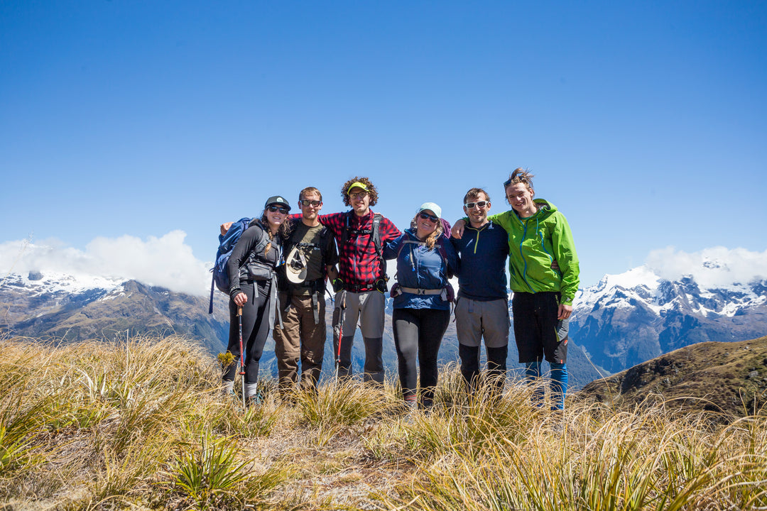 Group hiking in tussock above Queenstown, New Zealand.